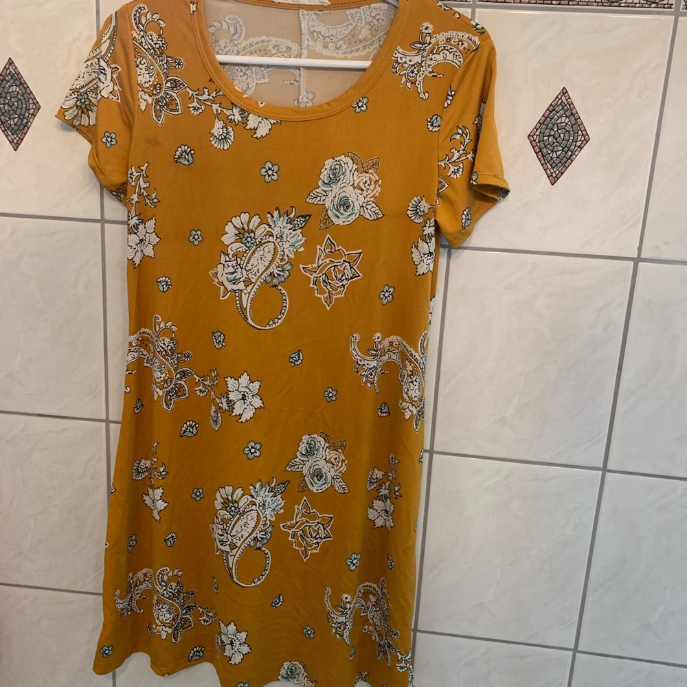 Mustard yellow knee length dress with floral pattern. Never worn.